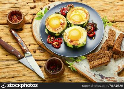 Fried eggs with tomatoes in plate on rustic wooden table.Fried eggs for healthy breakfast. Fried eggs or scrambled eggs