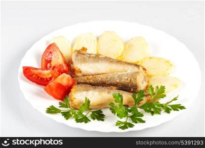 Fried fish and potato dinner on white