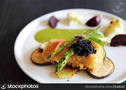 Fried fish fillet with green sauce