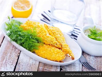 fried fish on plate and on a table