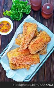 fried fish on tray and on a table
