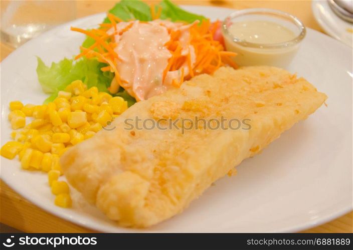 Fried fish steak with vegetables and corn
