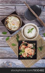 fried herbal vegetables with shrimp served with steamed rice and fried eggs. fried herbal vegetables with seafood