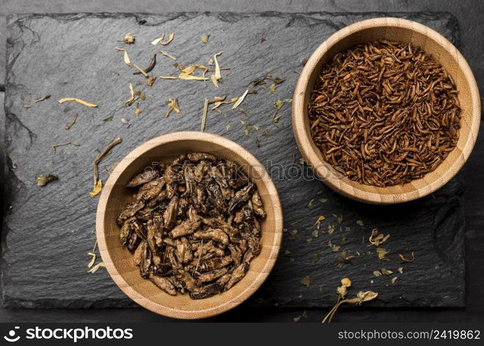 fried insects wooden bowl top view