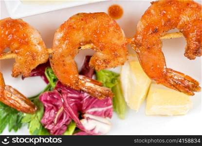 Fried kebab of shrimps with vegetables and sauce