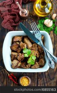 fried liver in bowl and on a table