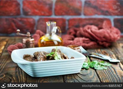 fried liver in bowl and on a table