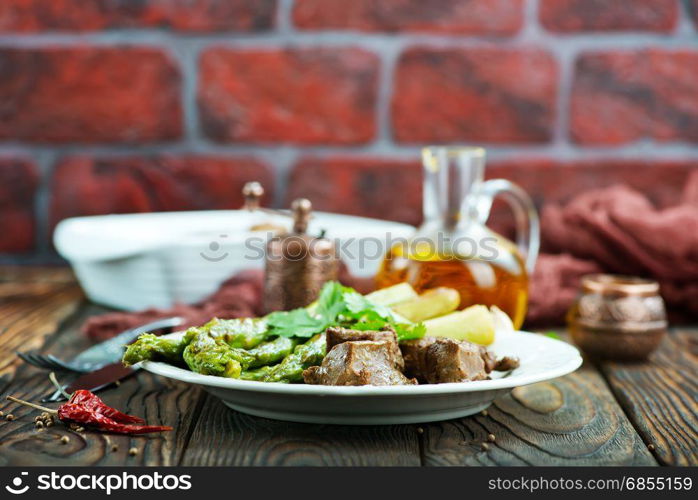 fried liver with asparagus on the plate