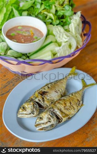 fried mackerel. fried mackerel with fresh vegetables and spicy sauce