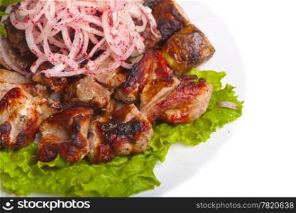fried meat and onions cooked over charcoal on a white background