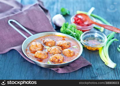 fried meat balls in the bowl and on a table