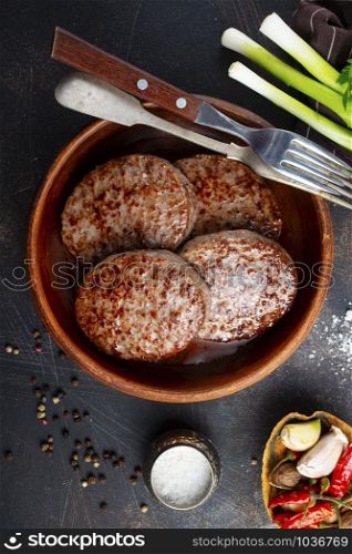 fried meat cutlet for burger in brown bowl