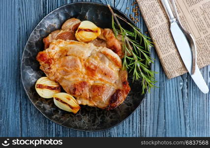 fried meat on plate and on a table