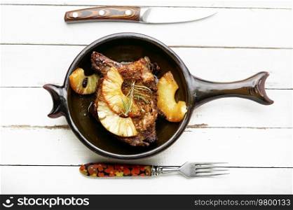 Fried meat ribs with pineapple. Grilled pork chop with pineapple. Roasted meat in marinade