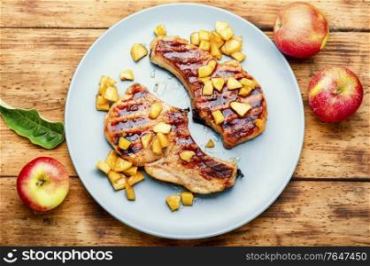 Fried meat steak with caramelized apple.Autumn food. Meat baked with apples