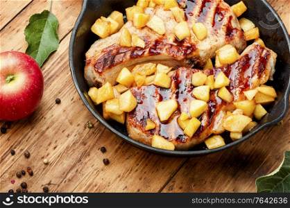 Fried meat steak with caramelized apple.Autumn food. Steak with caramelized apple in a pan