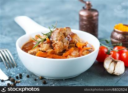 fried meat with tomato sauce in the bowl