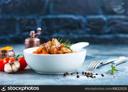 fried meat with tomato sauce in the bowl