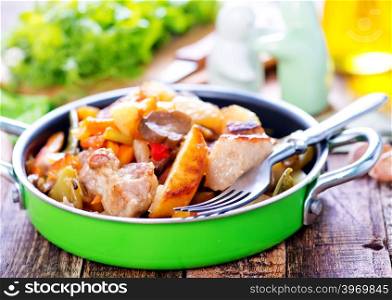fried meat with vegetables in the bowl