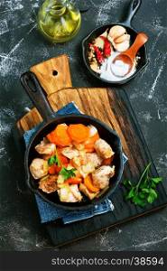fried meat with vegetables in the pan