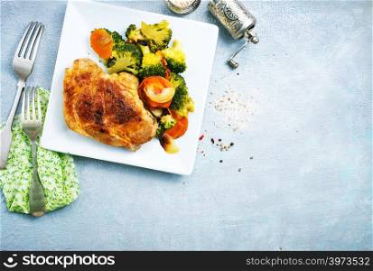 fried meat with vegetables on white plate