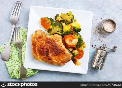 fried meat with vegetables on white plate