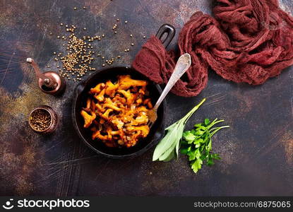 fried mushrooms in pan and on a table