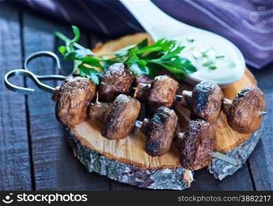 fried mushrooms on the wooden board and on a table