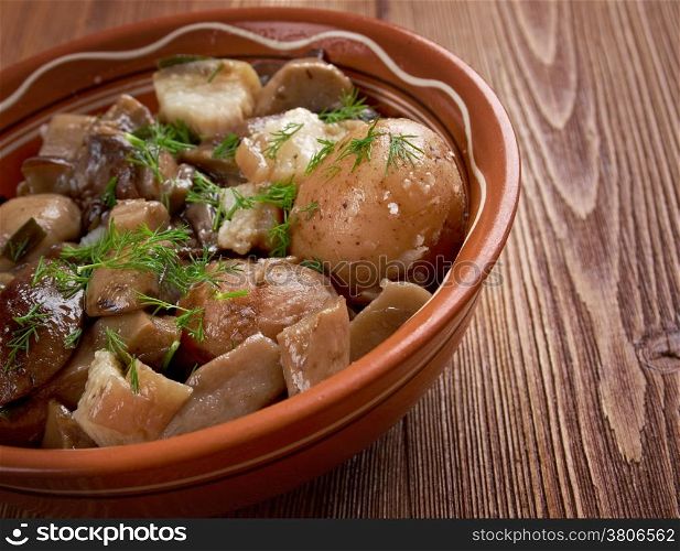 Fried mushrooms with bacon and potatoes.food at a rural