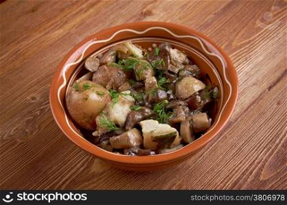 Fried mushrooms with bacon and potatoes.food at a rural