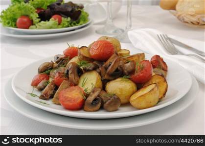 Fried mushrooms with sliced tomatoes and potatoes