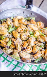 Fried mussels on the pan