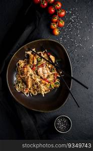 Fried noodles with chicken and vegetables. chicken chow mein.