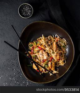 Fried noodles with chicken and vegetables. chicken chow mein.