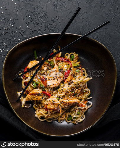 Fried noodles with chicken on top view