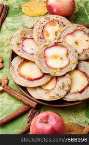 Fried pancakes filled with ripe autumn apples.Autumn dessert.. Fried pancakes with apples