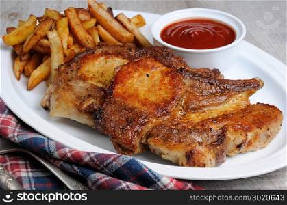 Fried pork loin steak with French fries and tomato sauce