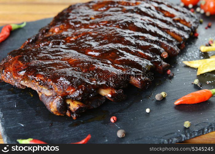 fried pork ribs and hot pepper on plate