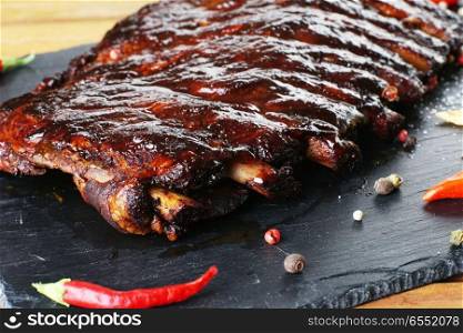 fried pork ribs and hot pepper on plate. pork ribs