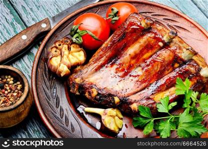 Fried pork ribs with tomato.American style pork ribs in barbecue. Tasty roasted ribs