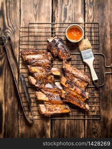Fried pork ribs with tomato sauce. On a wooden table.. Fried pork ribs with tomato sauce.