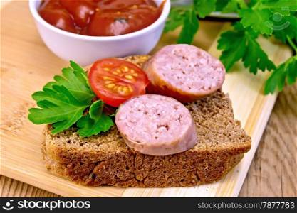 Fried pork sausage on a slice of bread with tomato and parsley, tomato sauce on a wooden boards background