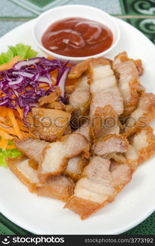 fried pork served with fresh vegetable and red sauce