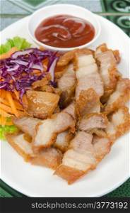 fried pork served with fresh vegetable and red sauce