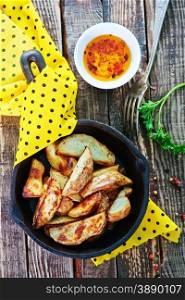 fried potato in pan and on a table