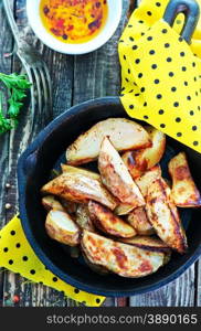 fried potato in pan and on a table