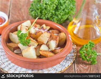 fried potato on plate and on a table