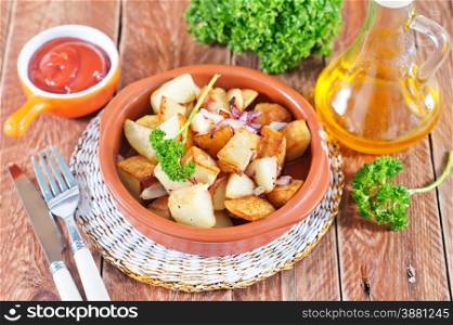 fried potato on plate and on a table