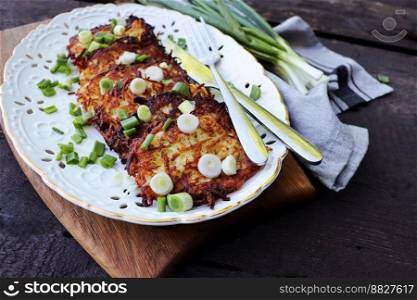 Fried potato pancakes on the old wooden background .. Fried potato pancakes on the old wooden background