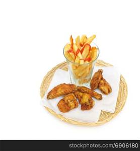 fried potato sliced as french fries in a glass and fried chicken drumsticks and wings on a paper serviettes in a wicker or bread basket over white background